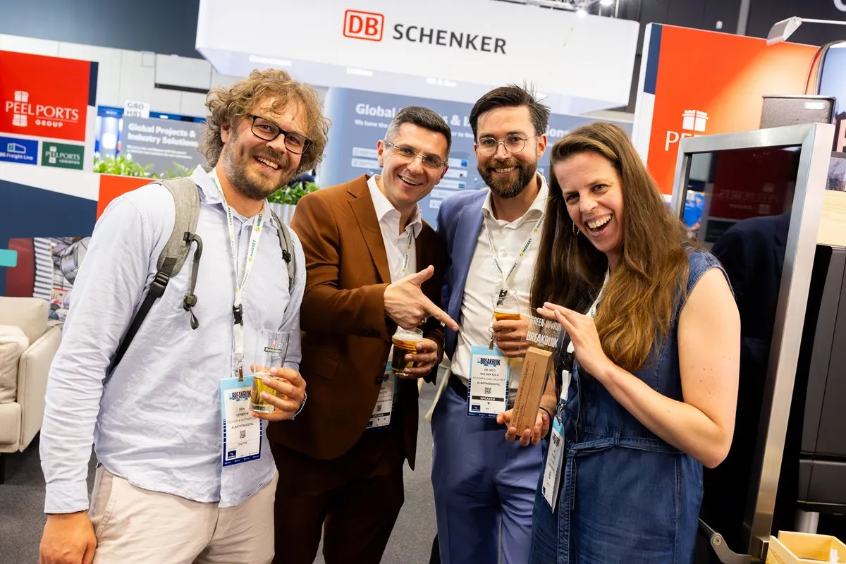 Attendees celebrate with a Green World Award at Breakbulk Europe.