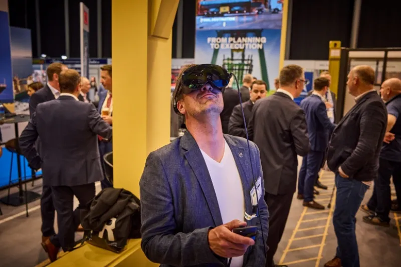 Attendee tries a virtual reality headset at Breakbulk Europe exhibition.