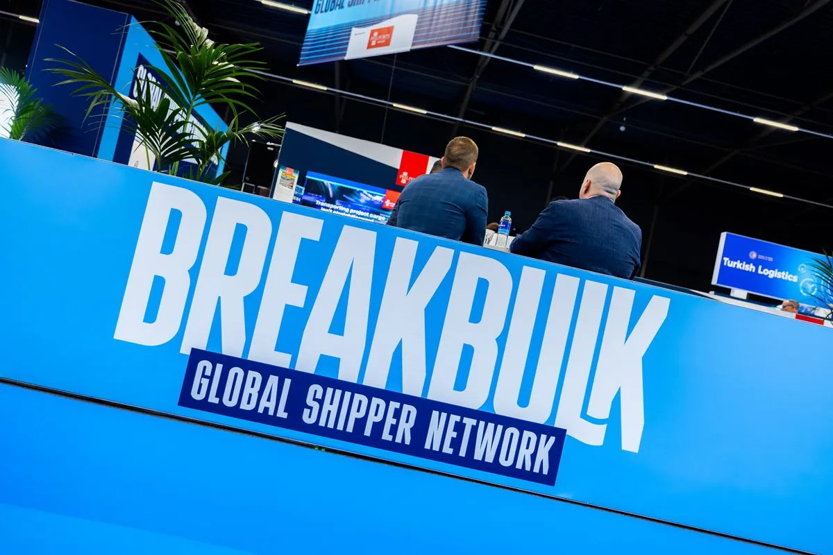 Breakbulk Global Shipper Programme stand at an industry event with attendees seated behind it.