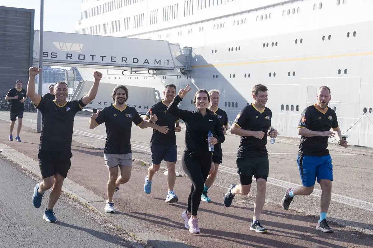 Participants run beside a ship during the Breakbulk Europe BUSINESSrun.