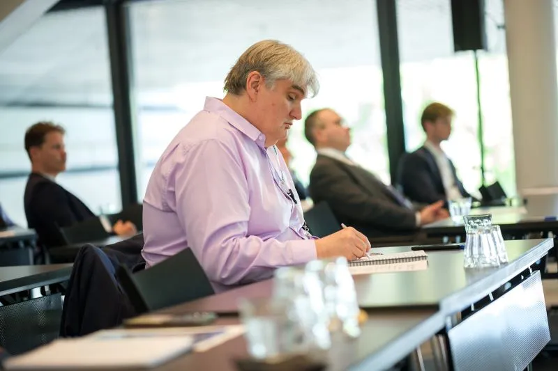 Attendee takes notes during a workshop session at Breakbulk Europe.