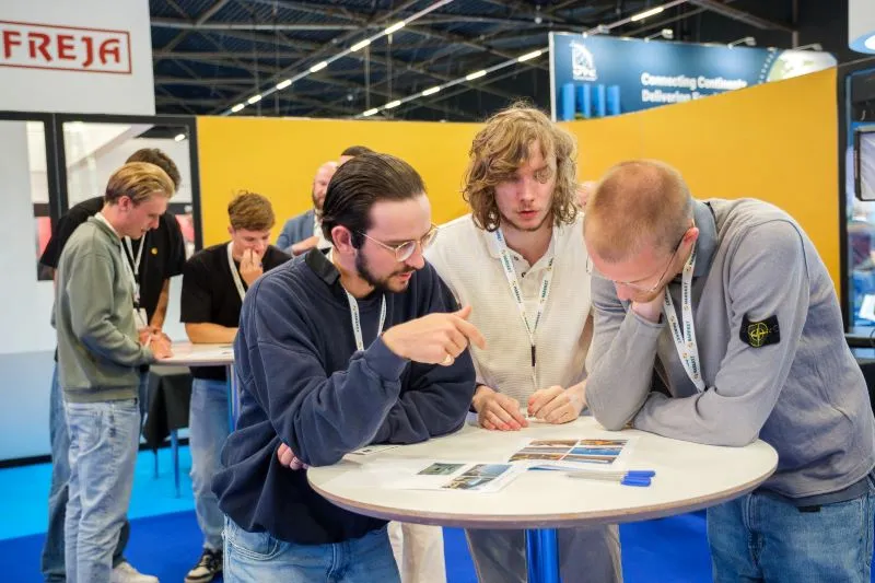 Breakbulk attendees networking and discussing project cargo logistics at the exhibition