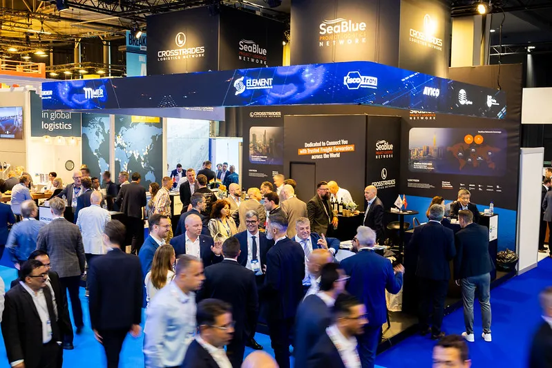 Breakbulk Europe show floor bustling with project cargo and logistics professionals networking.