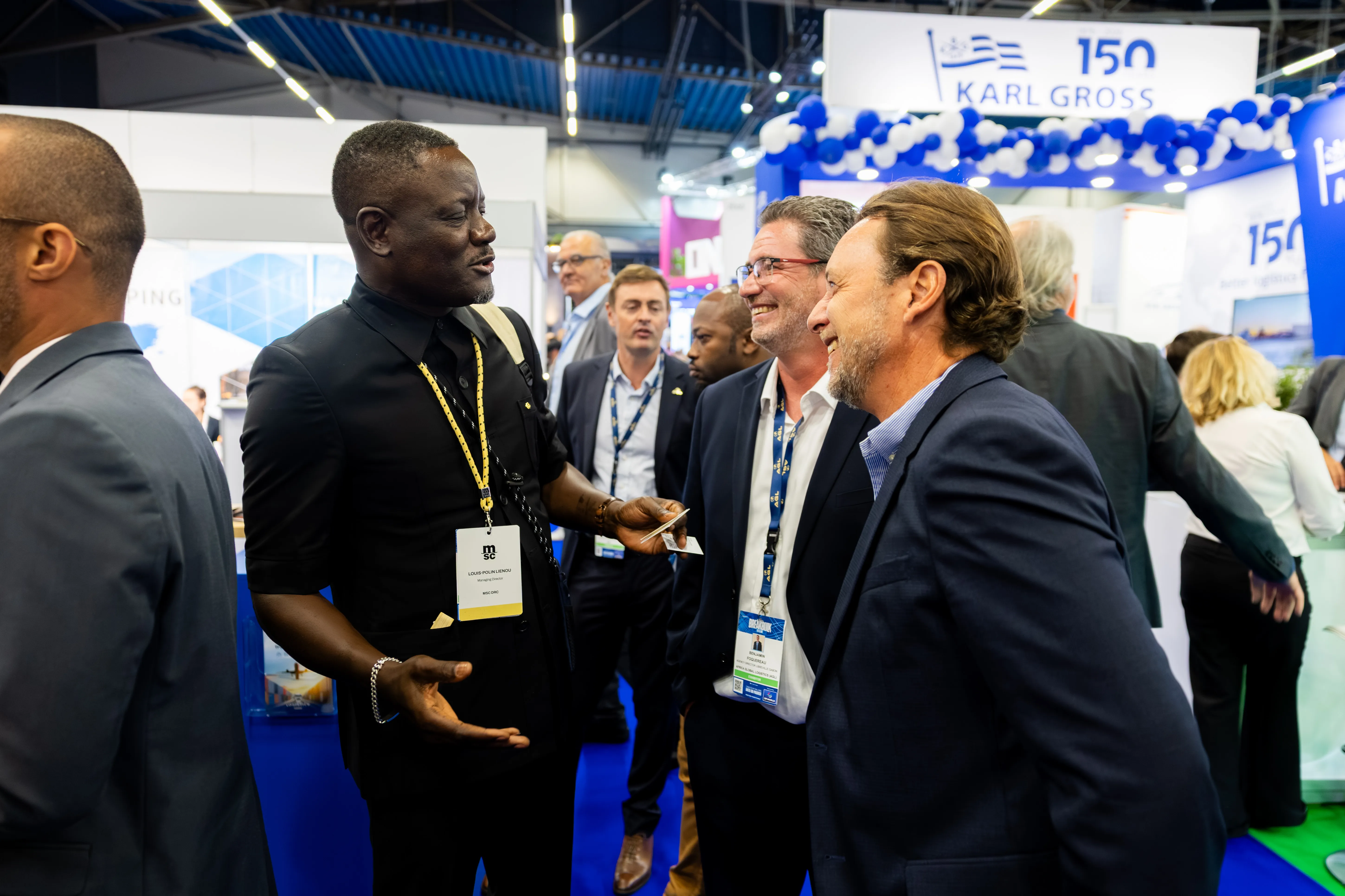Industry professionals network near the Karl Gross stand at Breakbulk Europe.