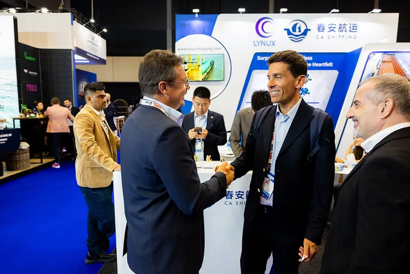 Breakbulk Europe attendees networking with logistics decision-makers at the exhibition.